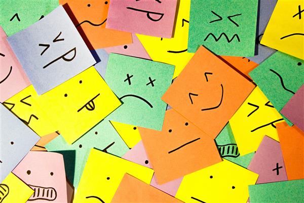  Many different colored post it notes with different facial emotions drawn on them